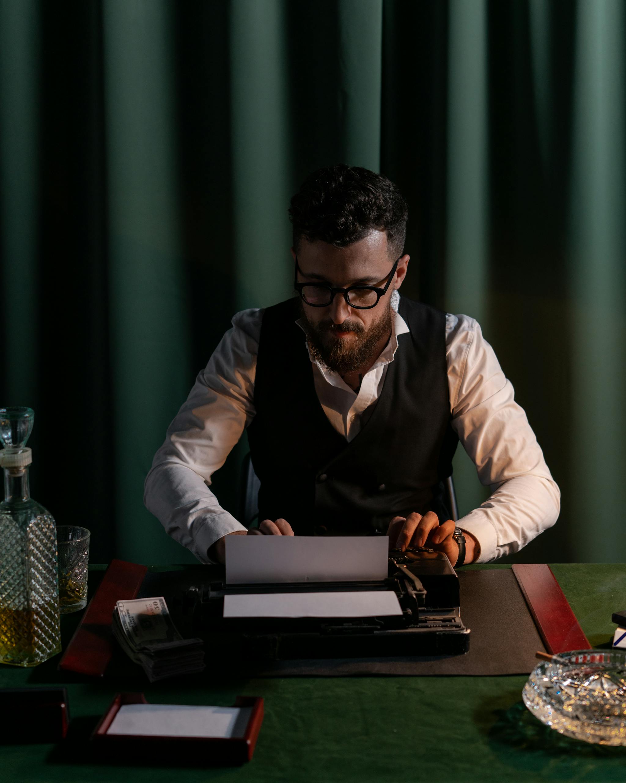 A classic scene of a focused man typing on a vintage typewriter in a dimly lit room.